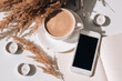 © anna.stasiia - Pampas grass and white cup with coffee. Mobile phone with black screen. Checking social media Drinking Cappuccino in the breakfast morning at home. Flat lay. Wallpaper. Aesthetics