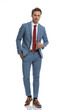 © Viorel Sima - attractive young man adjusting blue suit and holding hand in pocket
