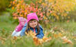 © Ermolaev Alexandr - Happy young girl with down syndrome lying on autumn leaves