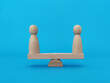 © ytemha34 - Wood people standing on scales on blue background, peaceful resolution and mutual benefit concept
