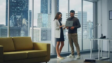 Poster - Successful Corporate CEO and Investment Manager Talking, Using Laptop Computer while Standing in Big City Office. Two Successful Diverse People Brainstorm Their e-Commerce Software Investment Strategy