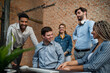 © Halfpoint - Cheerful young businesspeople having fun in office, social inclusion and cooperation concept.