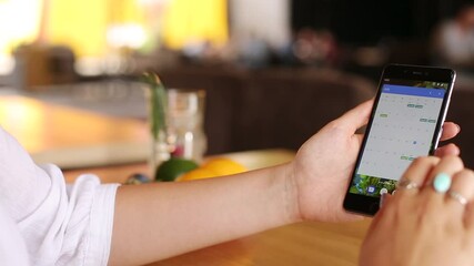 Wall Mural - female scanning fingerprint on her smartphone for secure login and privacy. woman unlocks mobile pho