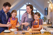 © yanlev - Family cooking in the kitchen at home