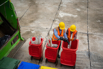 Wall Mural - Workers in the street are loading a garbage truck,Garbage Bin Collection,Waste collector with rubbish and trash.