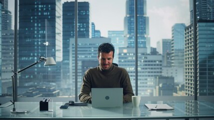 Wall Mural - Portrait of Thoughtful Businessman Working on Laptop Computer in His Big City Office. Charismatic Digital Entrepreneur does Data Analysis for e-Commerce Strategy assessment. Zoom In Front View