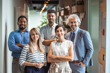 Smiling professional business coaches leaders mentors posing together with diverse office workers interns group, happy multicultural staff corporate employees people looking at camera, team portrait