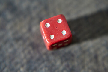 Wall Mural - Closeup shot of red dice with four dots isolated on gray background