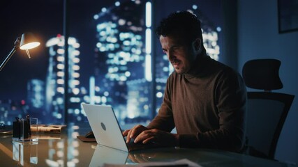 Poster - Portrait of Thoughtful Successful Businessman Working on Laptop Computer in His Big City Office at Night. Energetic Digital Entrepreneur does Data Analysis for e-Commerce Strategy. Medium Arc Shot