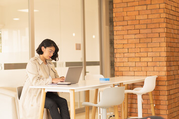 Wall Mural - Beautiful young, short-haired woman working on the laptop.