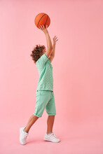 Caucasian Boy Basketball Player Holding And Toss Up Game Ball