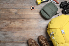 Flat Lay Composition With Tourist Backpack And Other Camping Equipment On Wooden Background, Space For Text