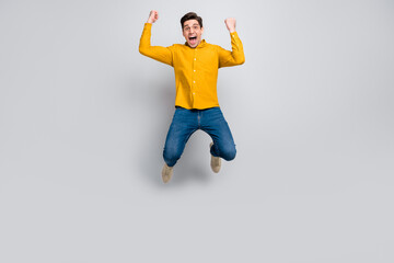 Poster - Full length body size view of attractive cheerful man jumping rejoicing attainment isolated over grey color background