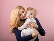 © rubchikova - mother and child isolated on pink.