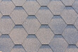 Flexible roof tiles. Roof covering materials. Asphalt shingle. Decorative bitumen shingles texture background. Close up top view.