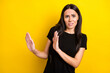 © deagreez - Photo portrait of girl in black t-shirt disgusted refusing ignoring isolated vibrant yellow color background