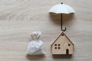 Protection, Model house and umbrella on white background, Finance insurance and Safe investment concepts