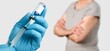 © BillionPhotos.com - Medical doctor hand in medical gloves holding a syringe.