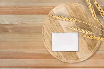 Wall Mural - Blank paper business card with mockup copy space and plants on wooden tray