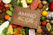 © New Africa - Wooden board with text AMINO ACIDS among different products, top view