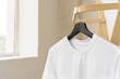 Plain white cotton t-shirt on hanger for your design