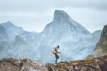 Wall Mural - Man hiking in mountains traveling solo with backpack outdoor active vacations in Norway healthy lifestyle extreme sports