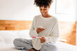 © (JLco) Julia Amaral - Woman taking a picture of her home pregnancy test
