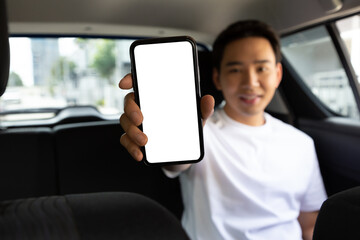 Passenger man showing empty application on mobile phone while sitting on back seat in car