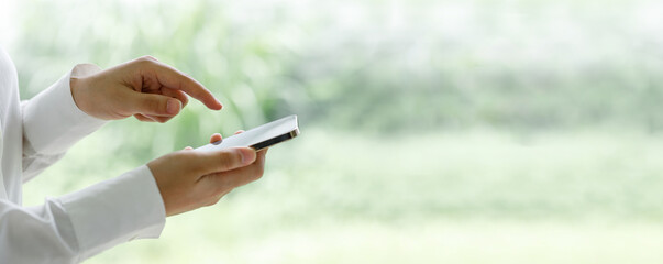 concept - close up of cell phone in hand with white background - easy modification