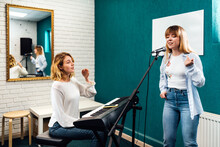 Woman Vocalist Singing In Microphone On A Vocal Lesson
