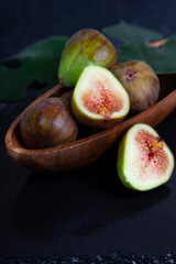 Wall Mural - Figs in a wooden plate and leaves