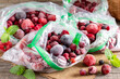 Mix of different frozen berries in a plastic bag on a table. Frozen food.