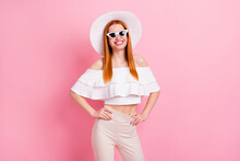 Portrait of attractive slender confident cheerful red-haired girl posing cool resort isolated over pink pastel color background