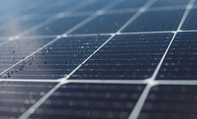 Close-up Of Dark Blue Solar Panel With Water Drops. Abstract Solar Panels Texture Background.