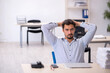© Elnur - Young male employee and too much work in the office