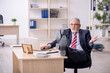 © Elnur - Old male employee working in the office