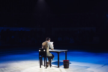 Concept. A lone Office worker sits in a dark room.