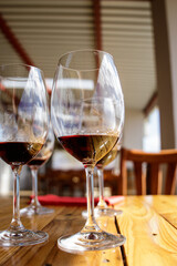 Sticker - Vertical shot of glasses of wine on the table in a restaurant