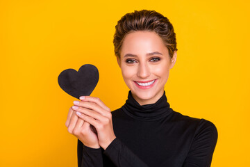 Poster - Portrait of attractive cheerful girl holding in hand heart sign amour discount isolated over bright yellow color background