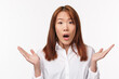 Oh my god what happened. Close-up portrait of concerned and shocked young woman raising hands sideways and gasping startled, hear bad news, showing empathy, stand white background