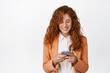 © Cookie Studio - Businesswoman chatting on mobile phone, wearing suit. Female office worker using smartphone, smiling as looking at screen, white background