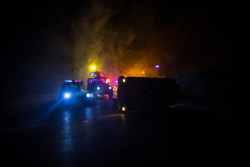 Wall Mural - Police car chasing a car at night with fog background. 911 Emergency response police car speeding to scene of crime.