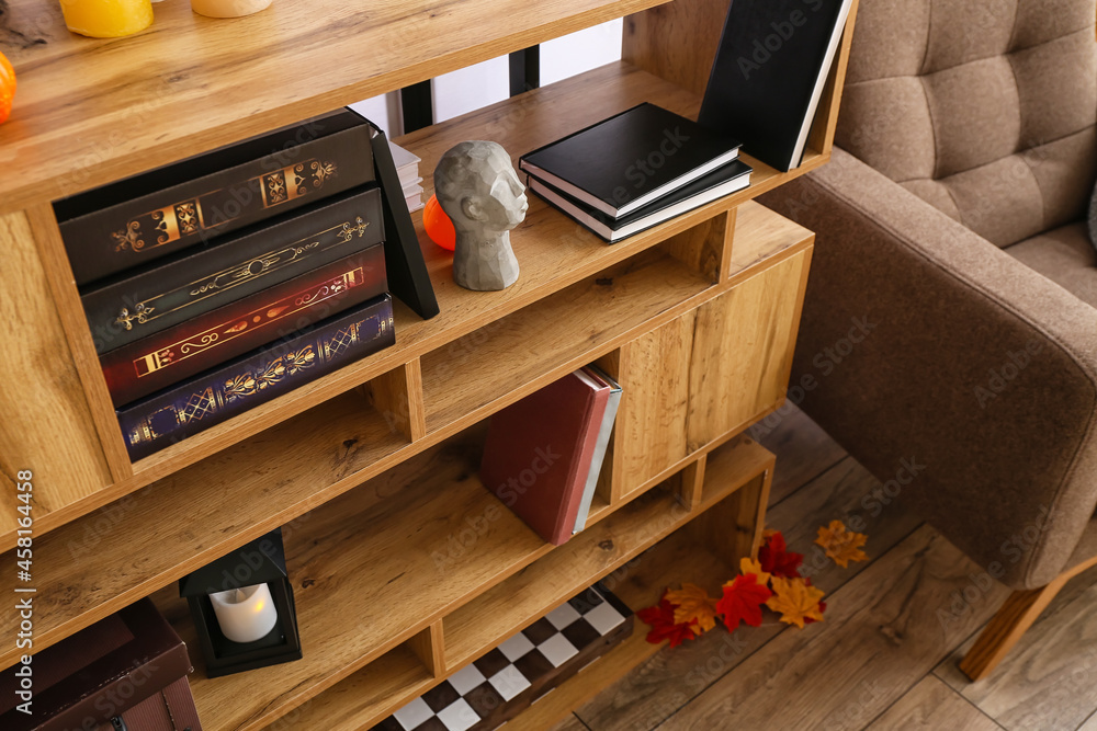 Wooden book shelf in room decorated for Halloween