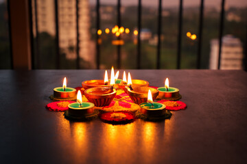 Diwali celebration Indian festival of lights Diya oil lamp and colors Rangoli decoration bright colorful  flowers flowerbed copy space greetings Dipavali Hindu festival North India, Mumbai Delhi India