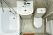 Top view of a small white bathroom. An example of a bathroom in a small apartment space.