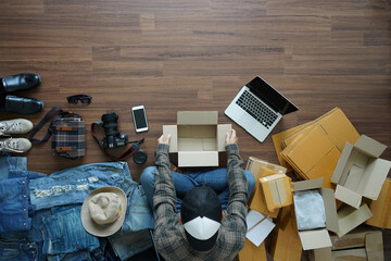  Top view of Man Selling online start up idea concept, Freelancer small business owner SME on wooden floor from home