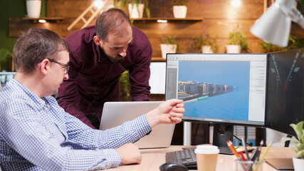 Graphic designer in game industry sitting at his office discussing video game graphic environment working at new illustration level Engineer editing production content using company 3d software