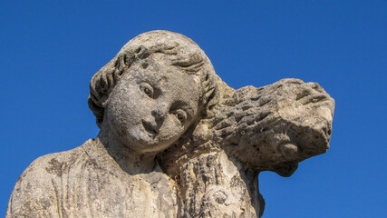 Wall Mural - The sculpture of an angel boy is made of stone