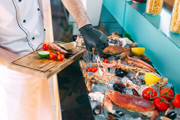 Wall Mural - The Chef puts the seafood on a tray in the restaurant.