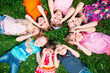 © davit85 - A group of children lying on the green grass in the Park. The interaction of the children.